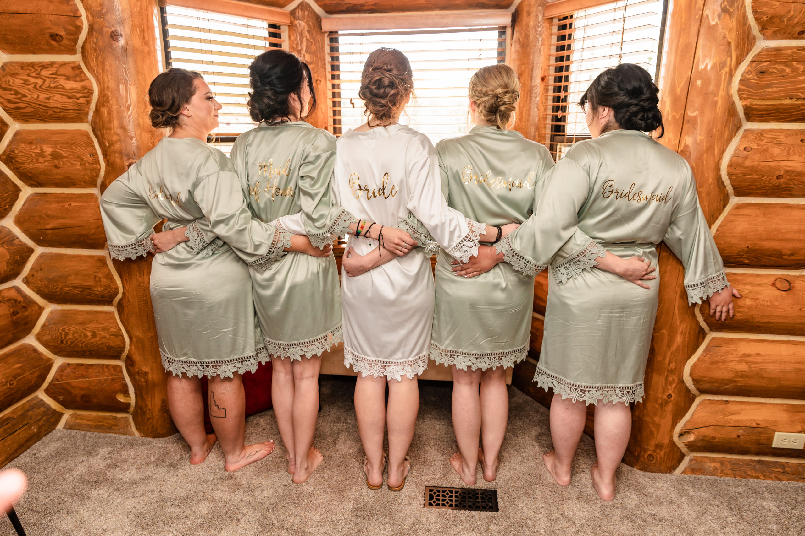bridesmaids and bride wearing robes at labelle lake wedding