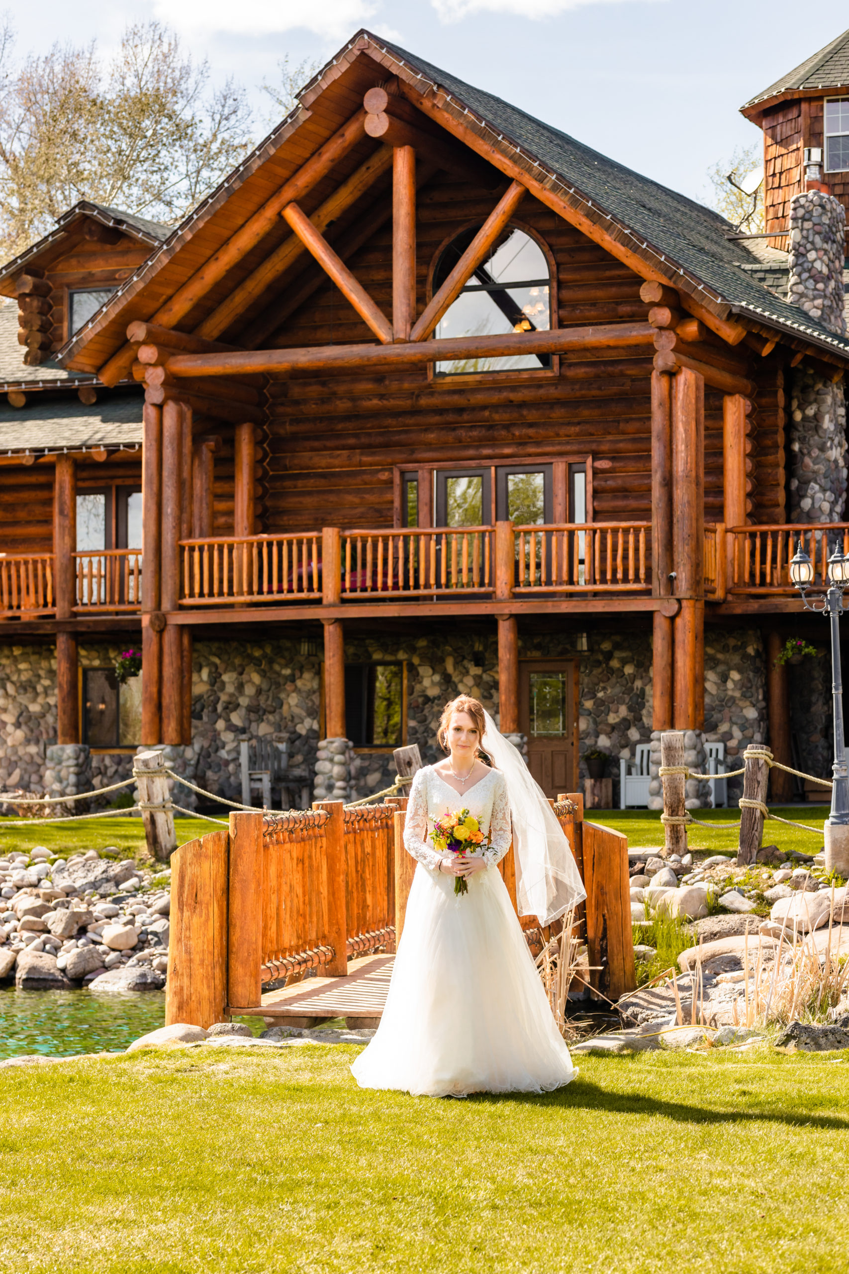 bride walking to become a wife with LaBelle Lake cabin behind her