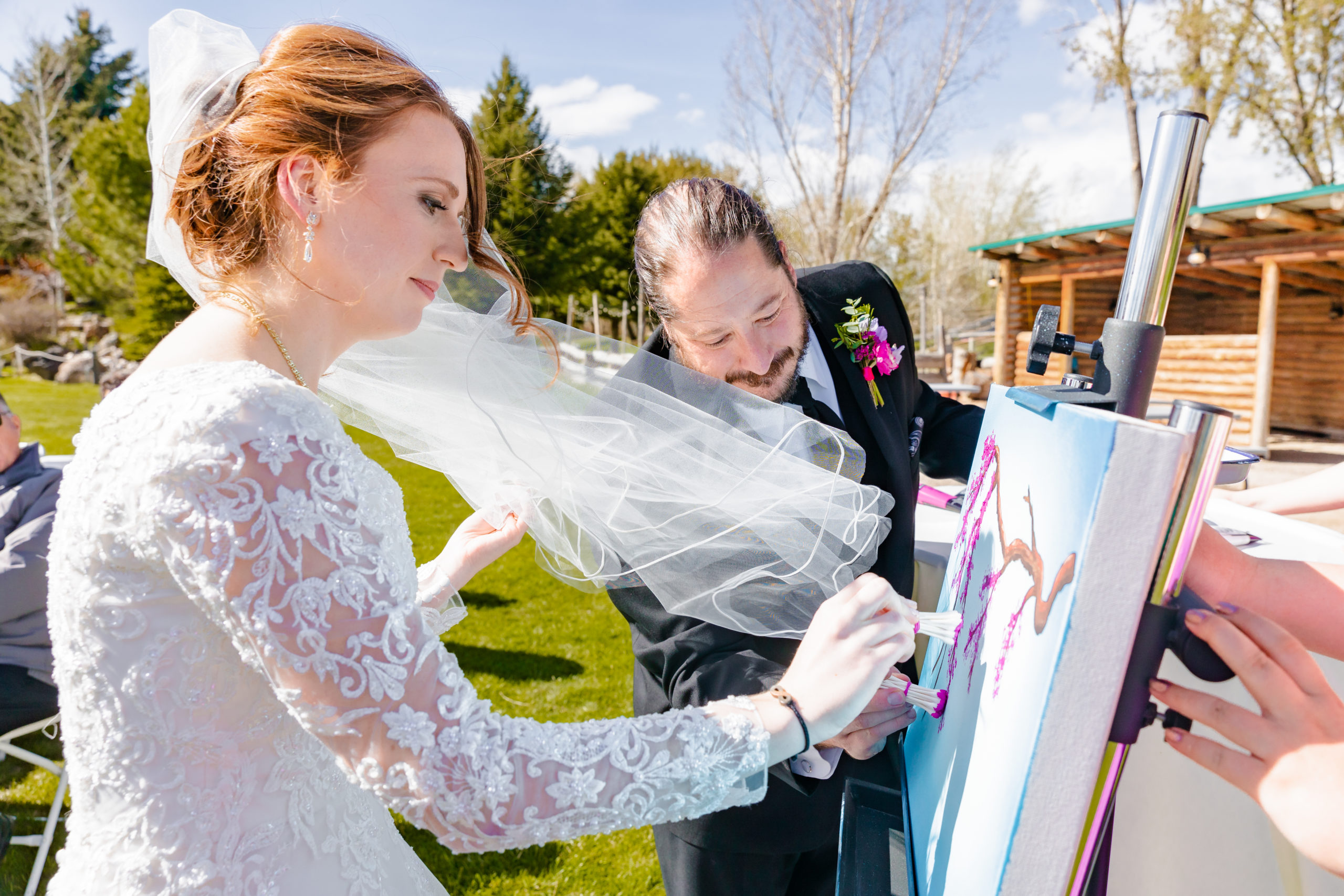 bride and groom painting at their wedding ceremony