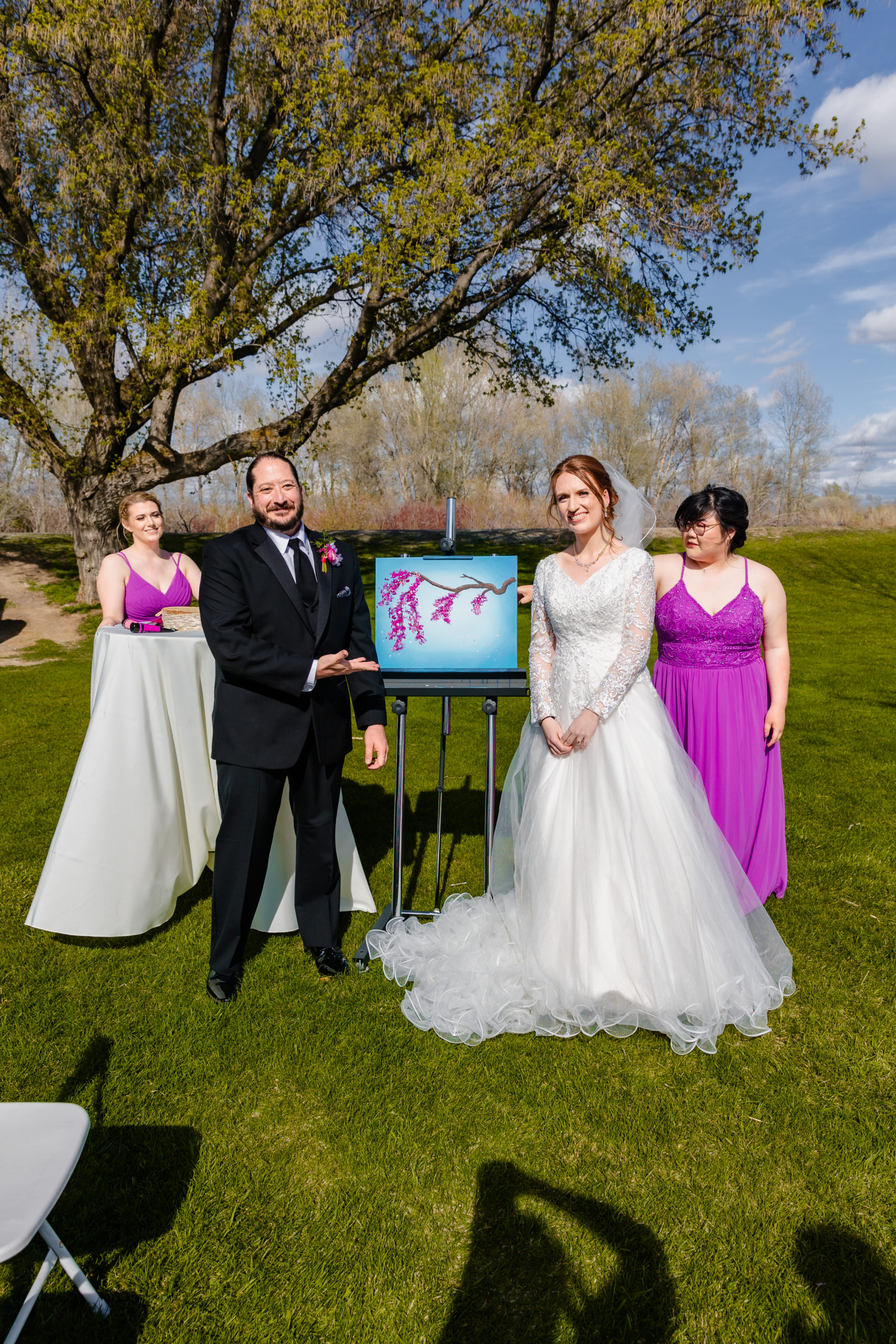bride and groom display painting at their wedding ceremony of cherry blossoms on branch