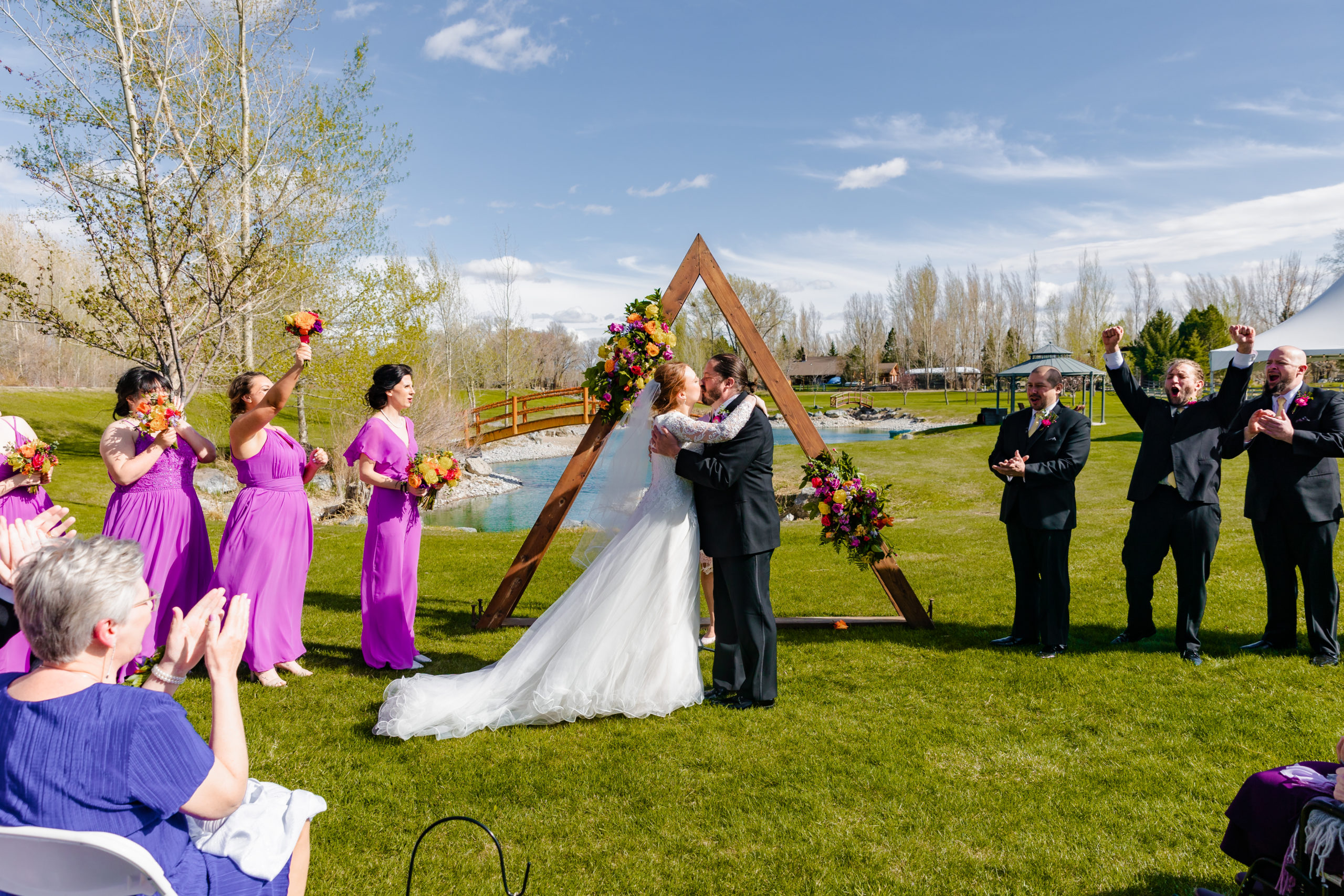 kissing as husband and wife bride and groom at Colorful LaBelle Lake Wedding