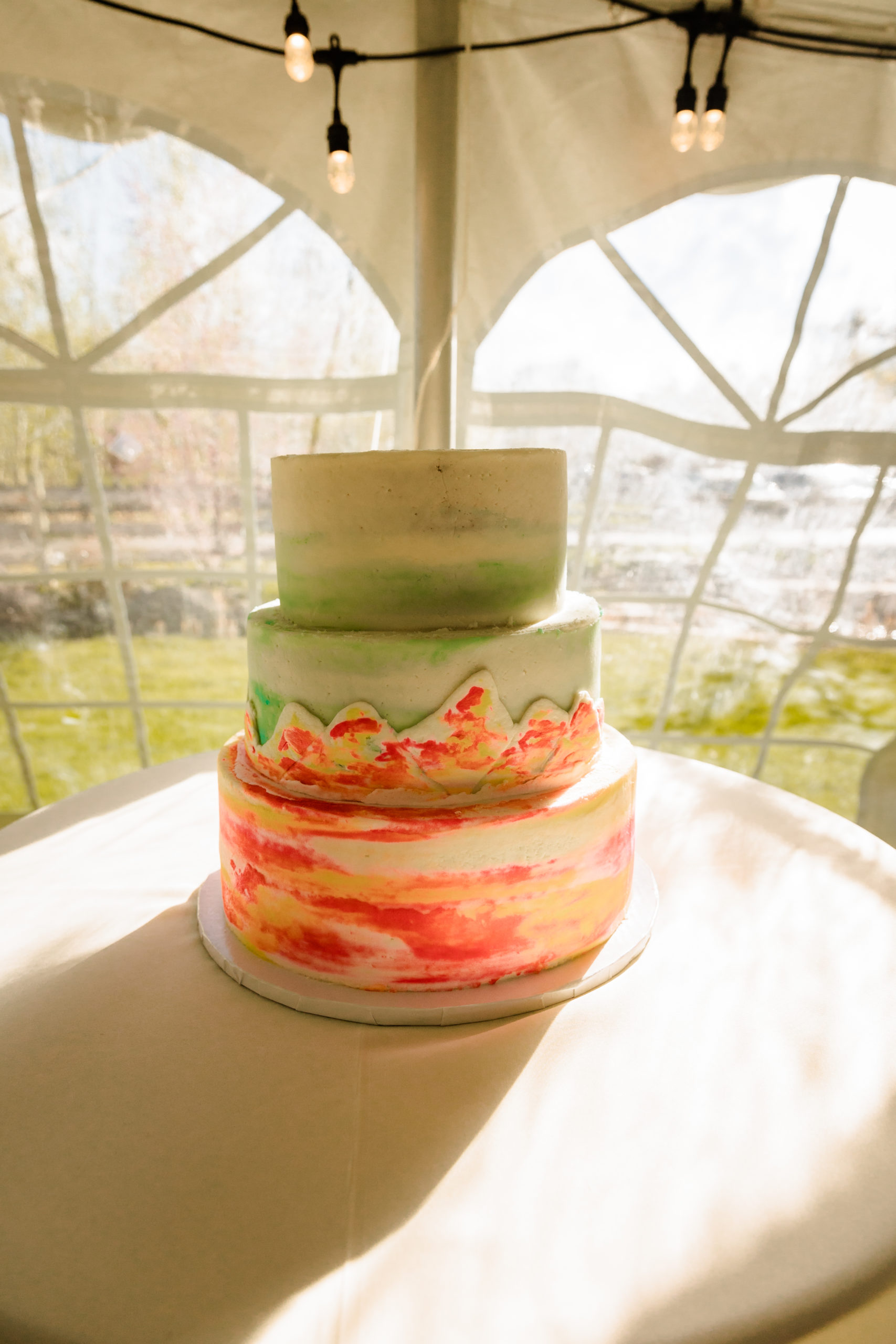 3 tiered wedding cake with Teton Mountain range on it