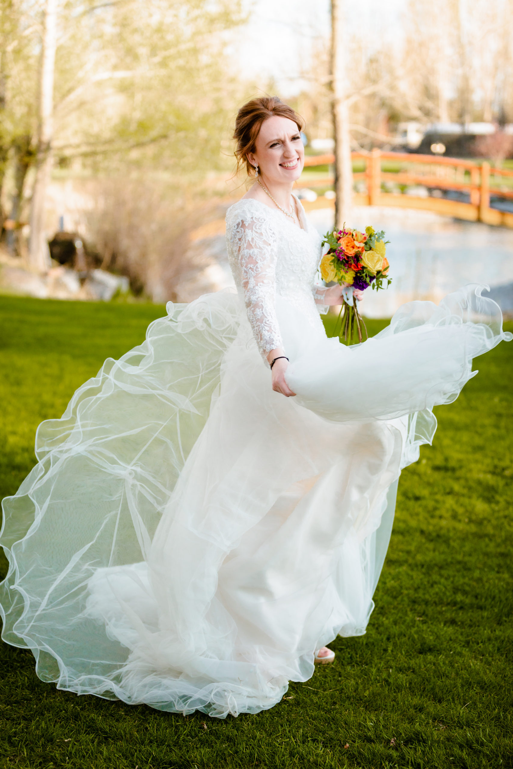 bride swinging dress around during bridal portraits before Colorful LaBelle Lake Reception