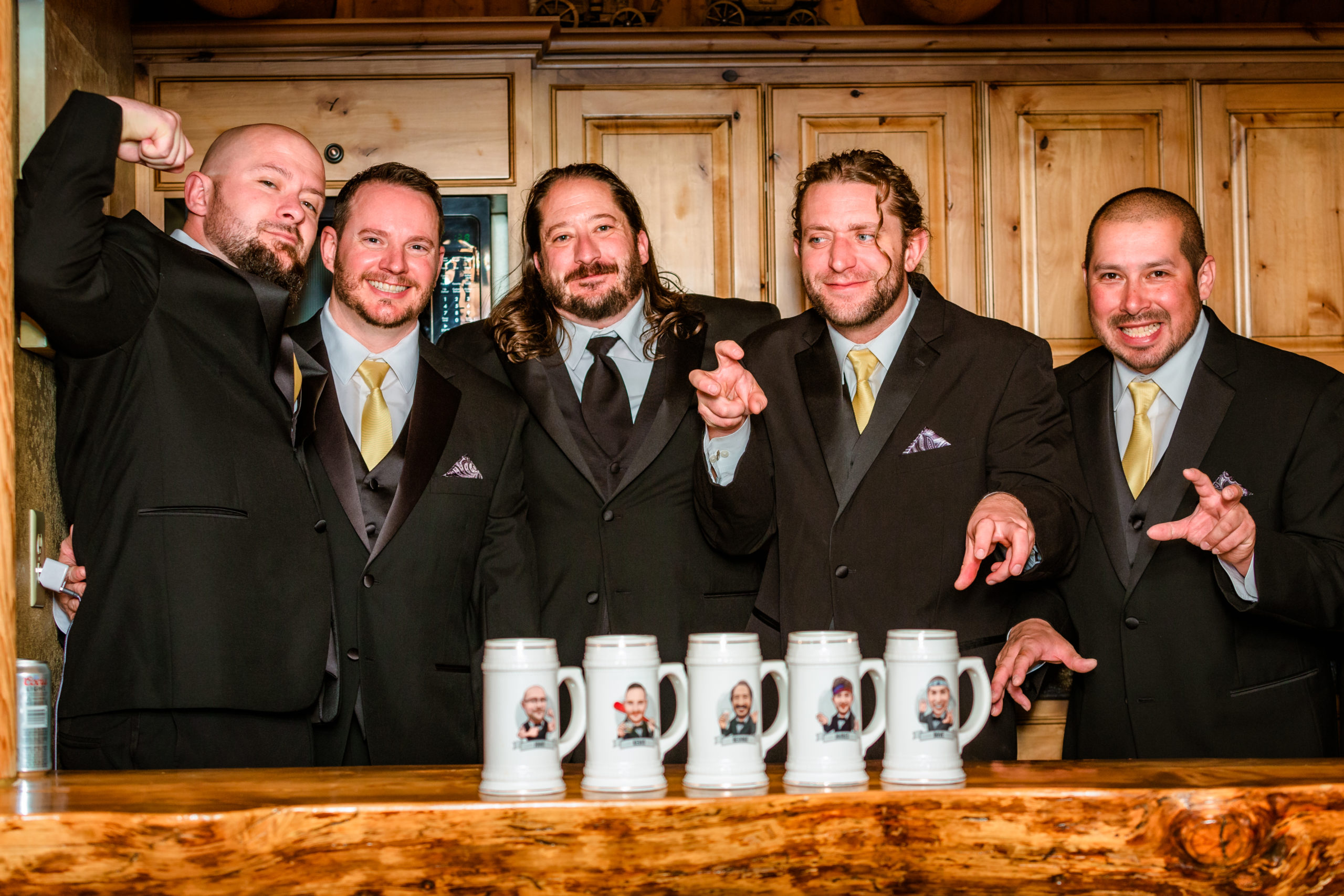 groom and groomsmen in tuxs posing with personalized beer mug