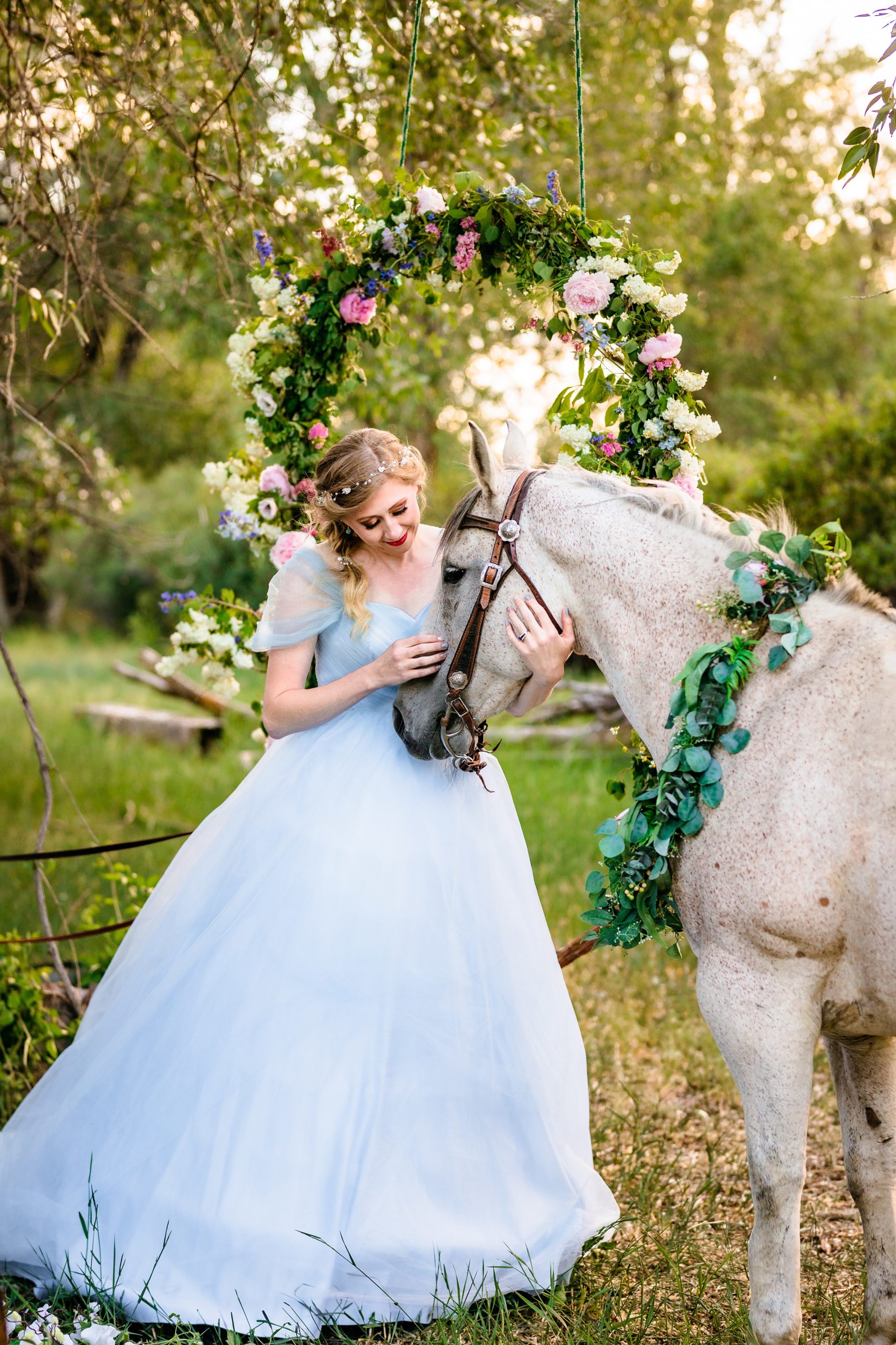 bride in blue dress pets horses nose