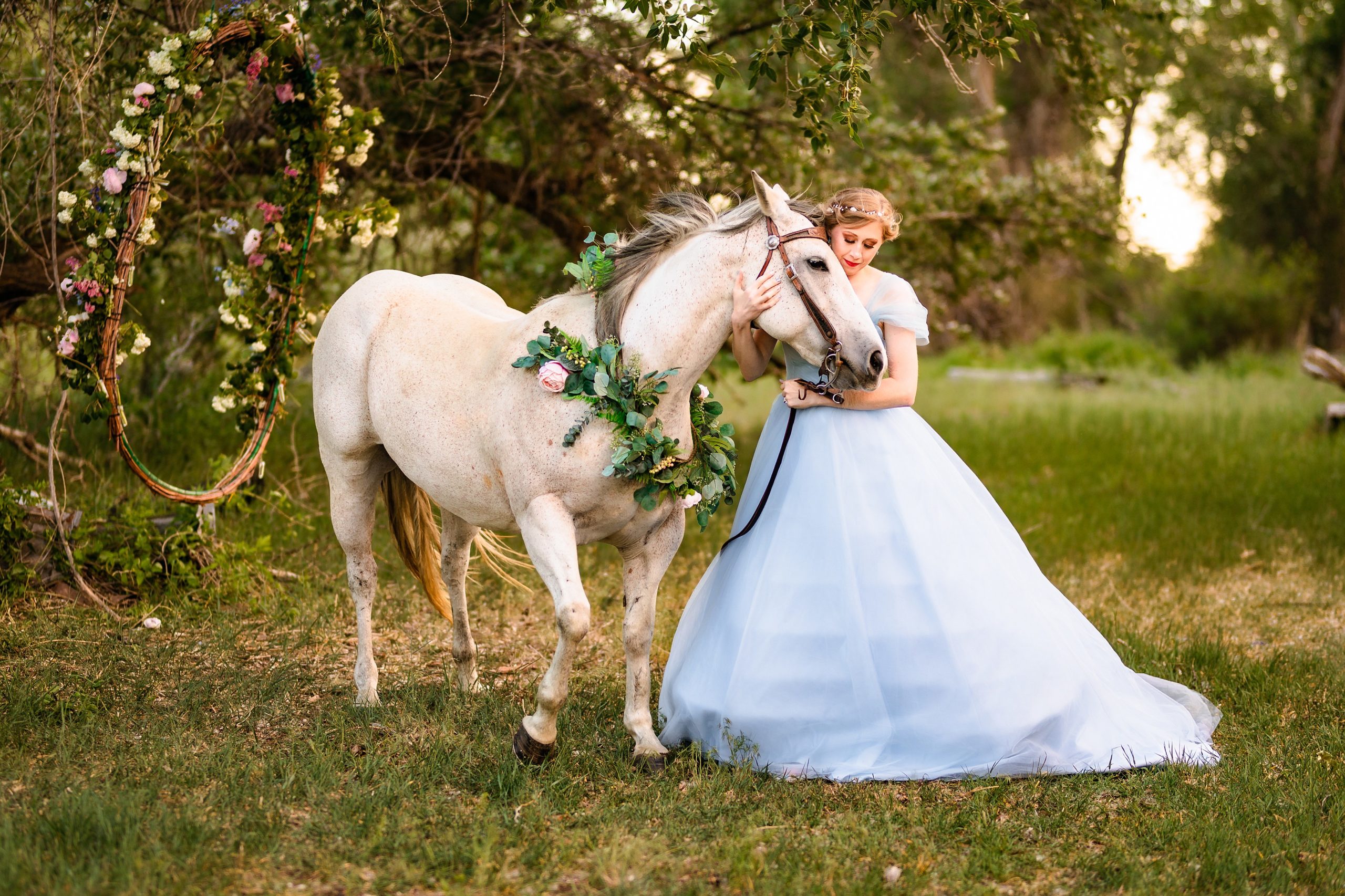white horse runs to bride in blue dress in forest