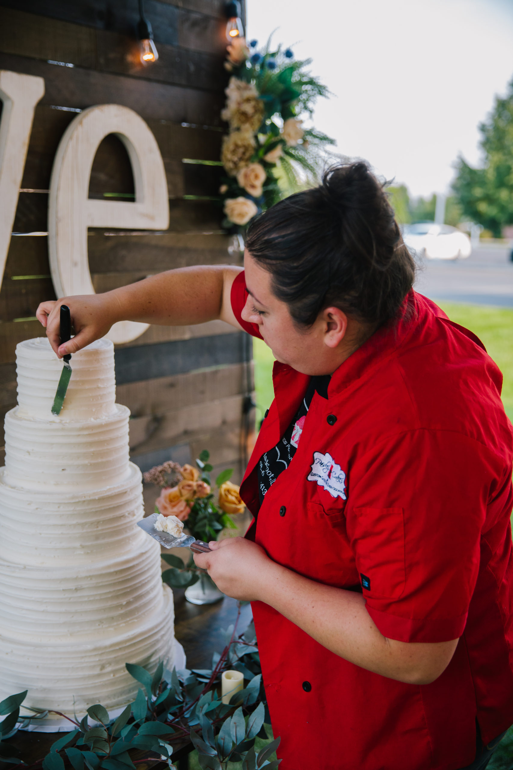 woman assembling wedding cake