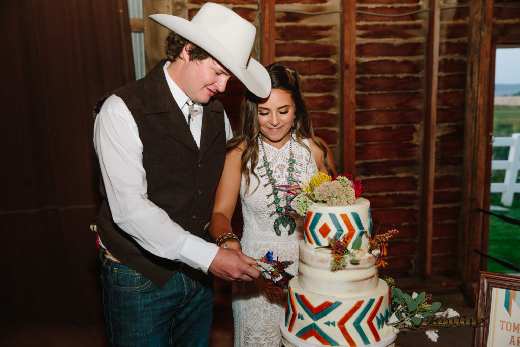 bride and groom cutting cake at Jackson Hole wedding 