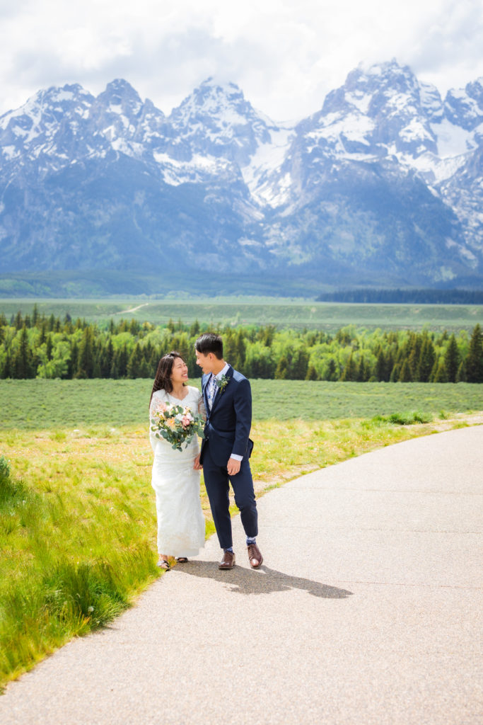 bride and groom walking hand in hand during bridals at grand teton national park