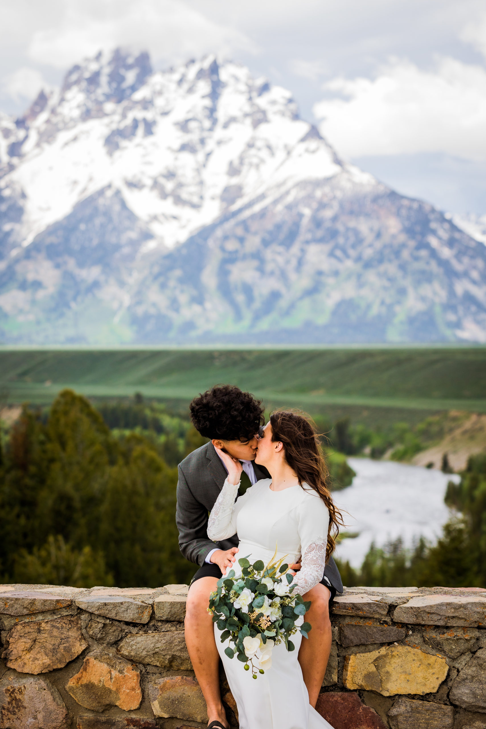 Snake River Overlook weddin gphotographers capture bride and groom kissing in front of the Grand Tetons