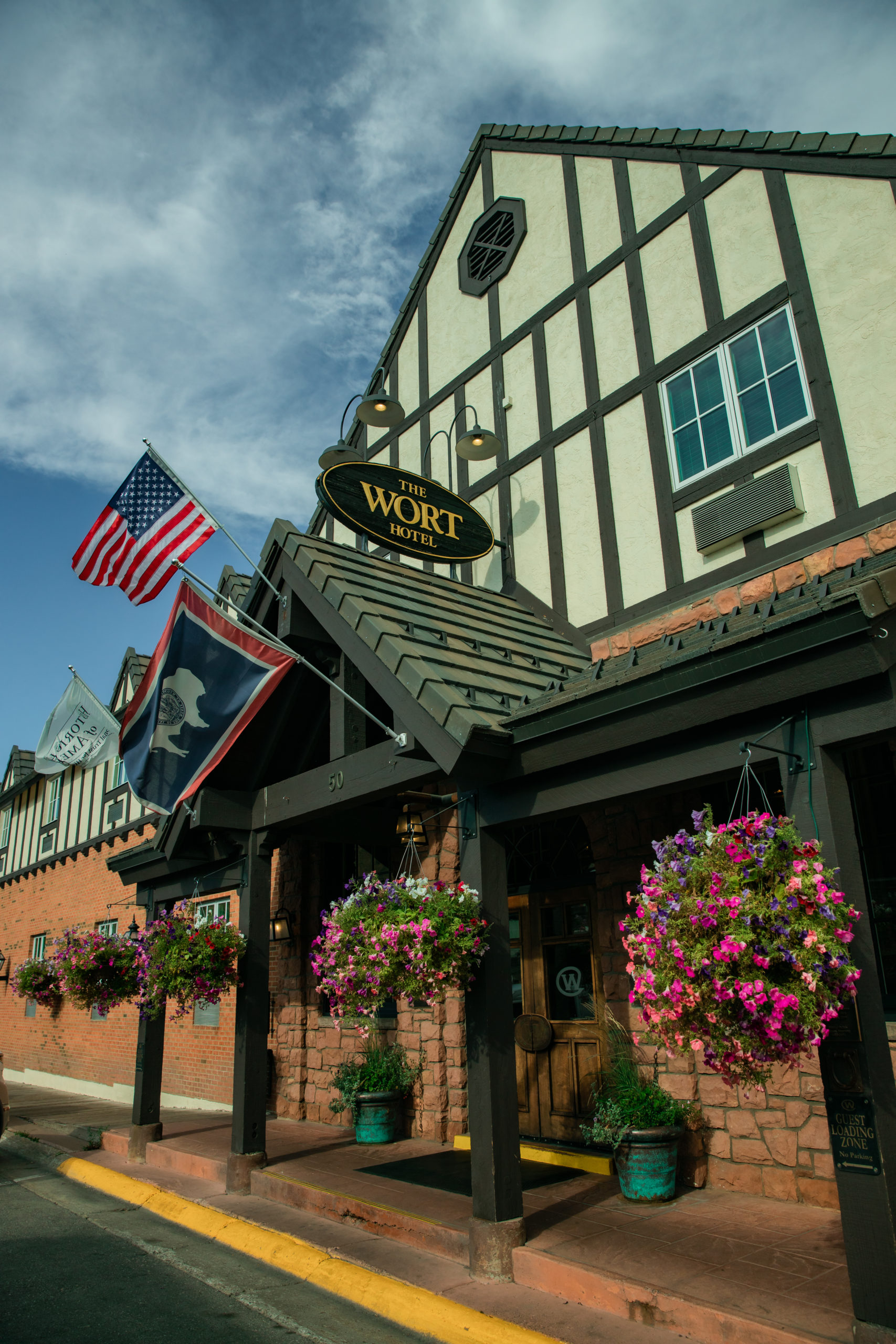 The Wort hotel and restaurant in Jackson Hole WY outside of building with flag and flowers
