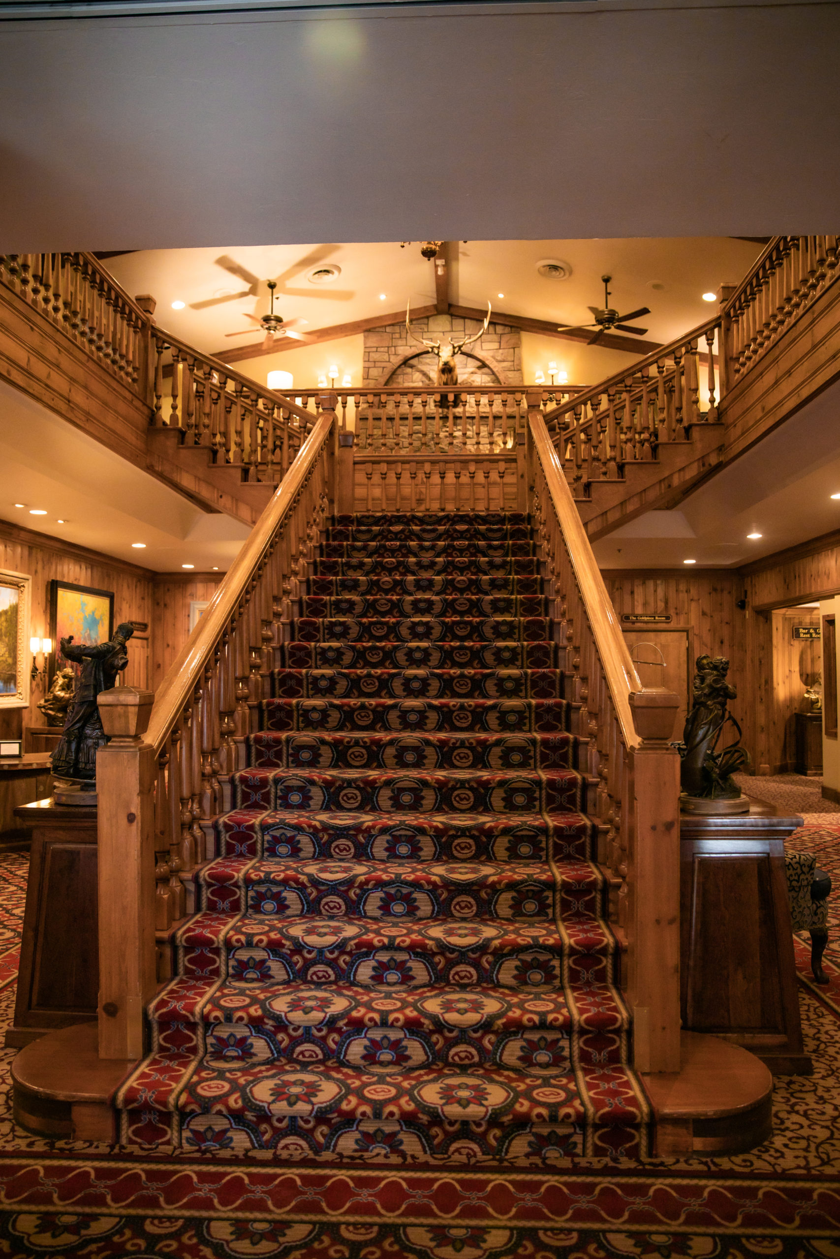 Carpeted staircase with oiled wood inside Jackson Hole Hotel The Wort 
