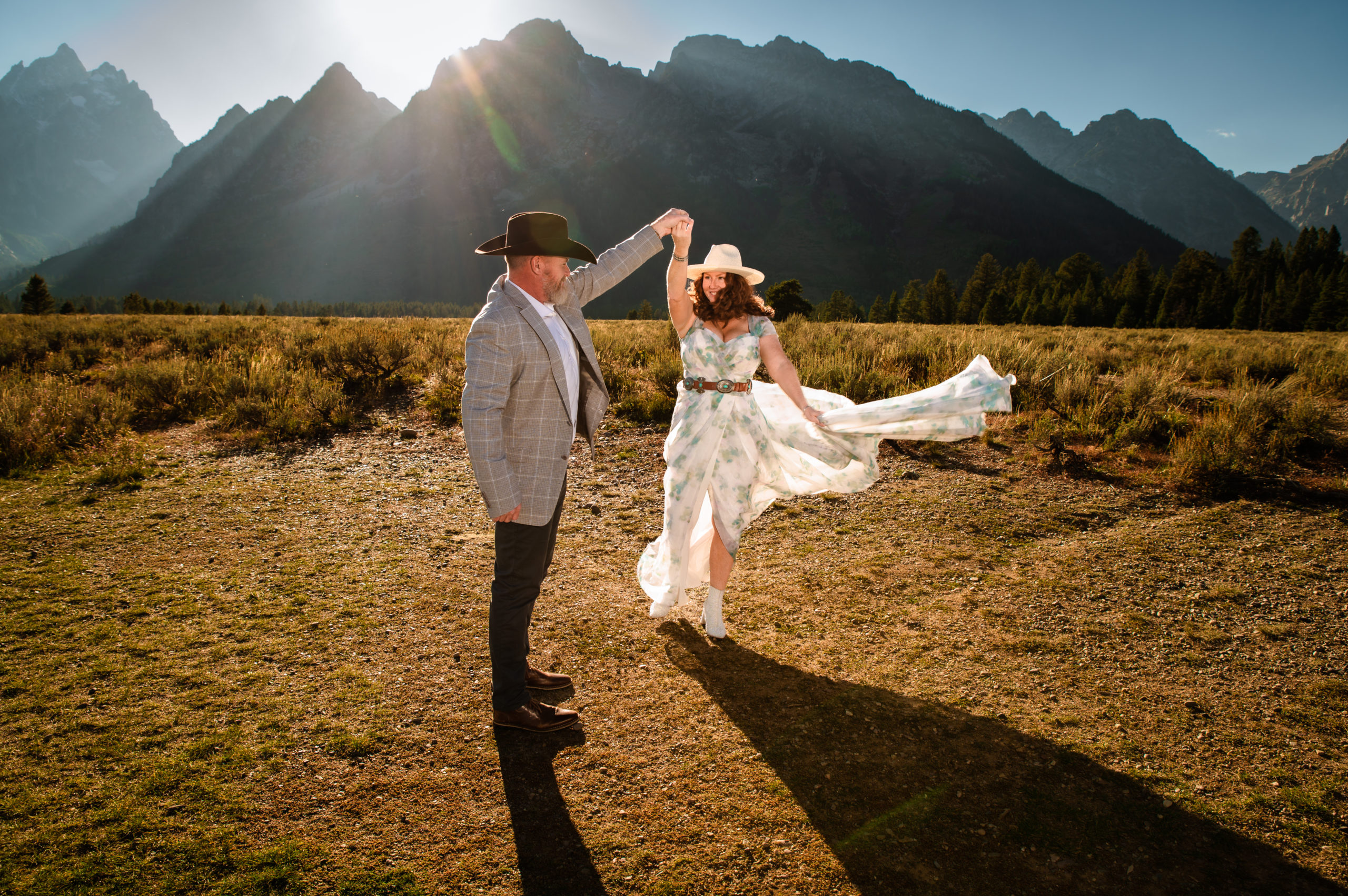 Jackson Hole wedding photographer captures bride and groom dancing together in Grand Teton National Park wedding