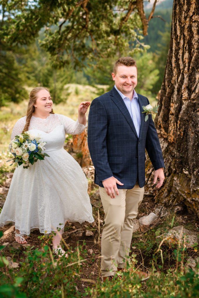 Jackson Hole wedding photographers capture bride and groom during first look before Windy Wedding Tree Elopement