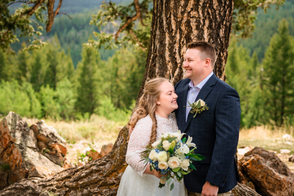Jackson Hole wedding photographer captures bride and groom laughing together after first look