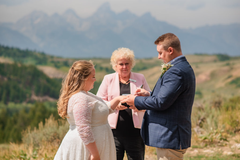 Jackson Hole wedding photographer captures bride and groom holding hands before becoming husband and wife