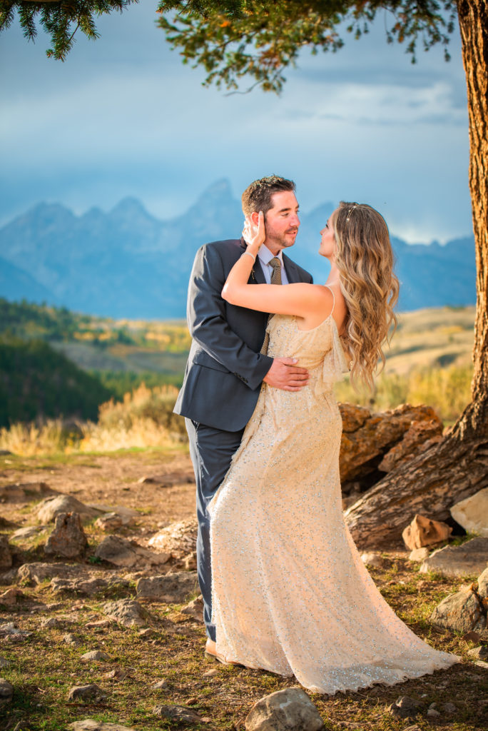 Jackson Hole wedding photographer captures man and woman embracing after using engagement photos in Jackson Hole wedding