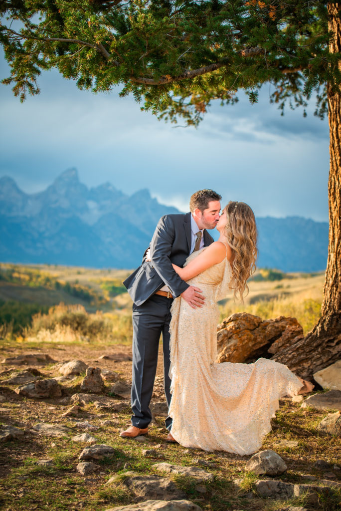 Jackson Hole wedding photographer captures man and woman kissing during engagement session in Grand Teton National Park
