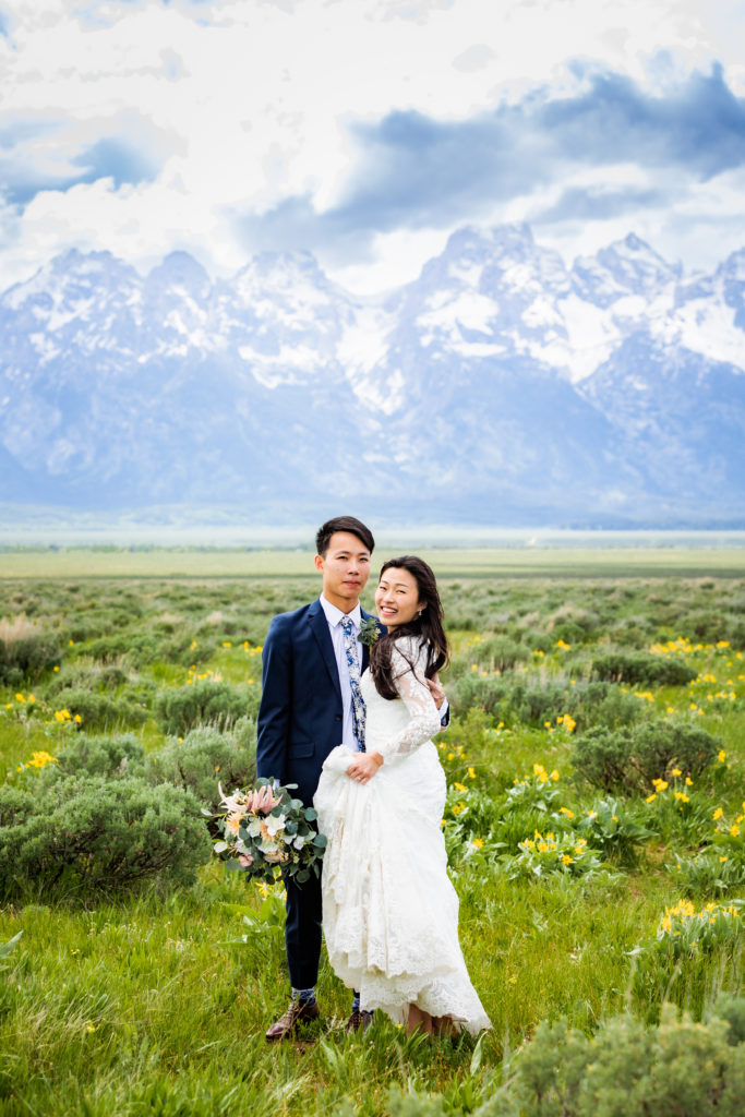 Jackson Hole wedding photographer captures bridal couple walking through grand teton national park