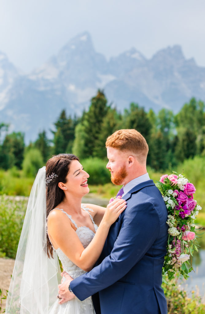 Jackson Hole wedding photographer captures newly married couple embracing during Grand Teton National Park wedding