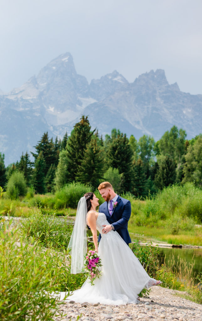 Jackson Hole wedding photographer captures bride and groom kissing during bridal portraits