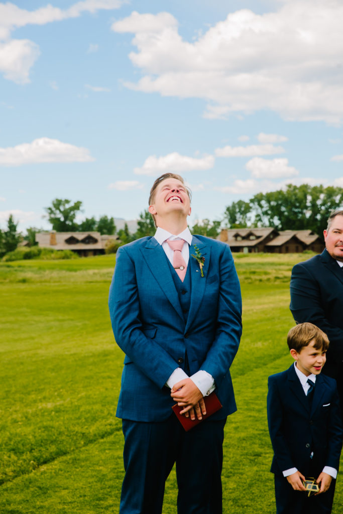 Jackson Hole wedding photographer captures groom smiling and getting emotional at classy jackson hole wedding venues