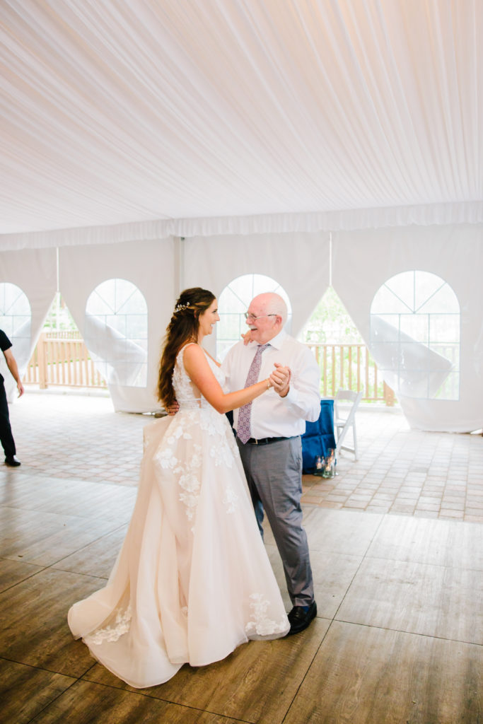 Jackson Hole wedding photographer captures bride dancing with father during father-daughter dance