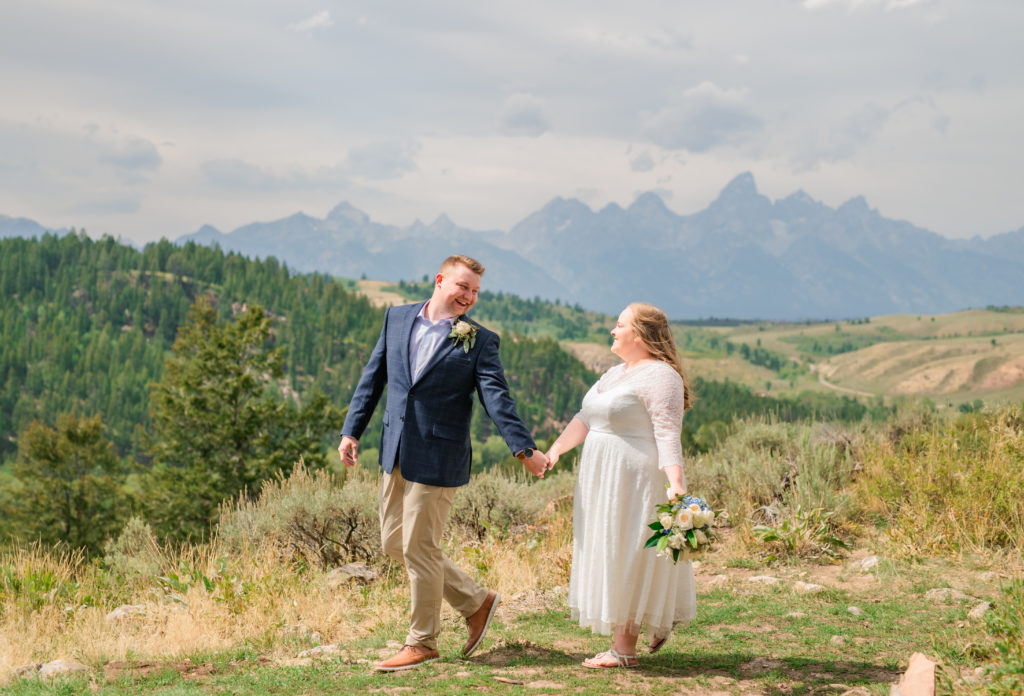 Jackson Hole elopement photographer captures bride and groom walking through Grand Teton National Park