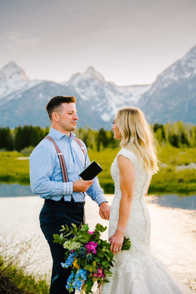 Jackson Hole wedding photographer captures groom reading vows to bride