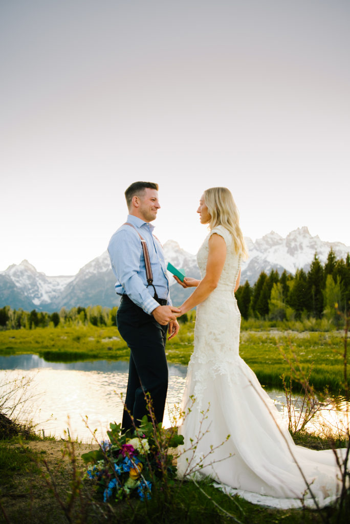 Jackson Hole wedding photographer captures bridal couple holding hands before Grand Teton National Park wedding