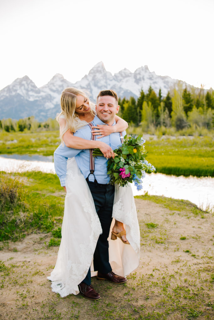 Jackson Hole wedding photographer captures bride and groom embracing during outdoor bridal portraits