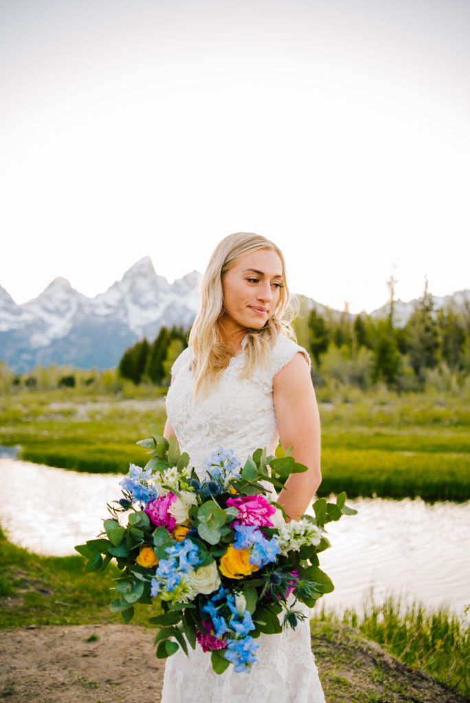 Jackson Hole wedding photographer captures bride holding colorful bouquet