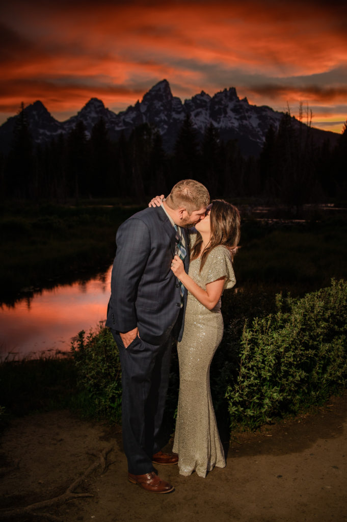 Jackson Hole elopement photographer captures bride and groom kissing at sunset