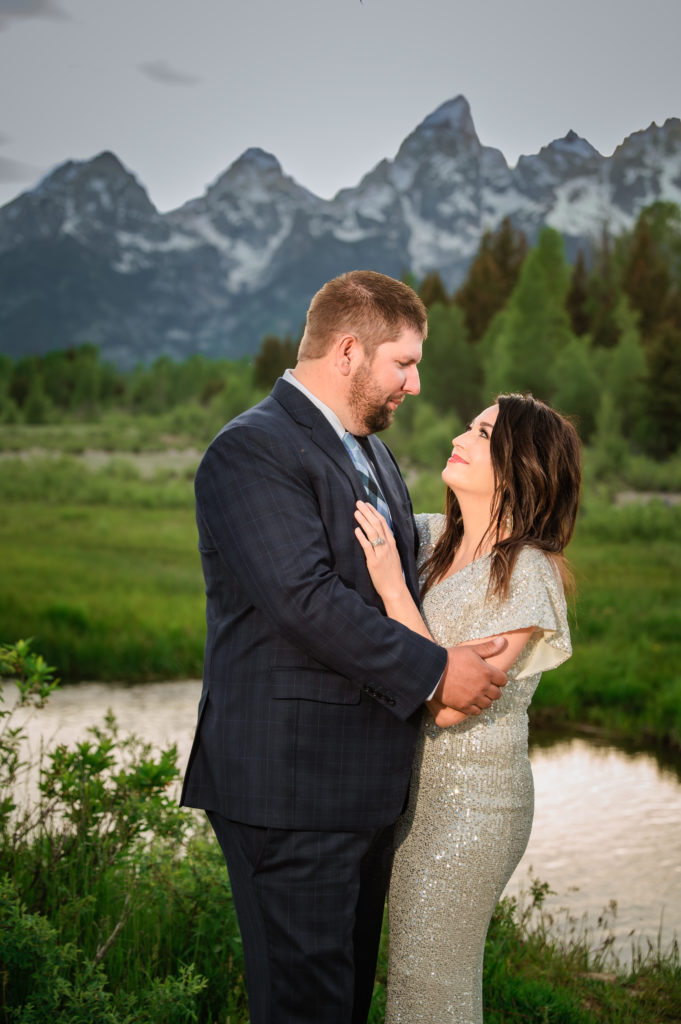 Jackson Hole elopement photographer captures newly married couple looking at one another after grand teton wedding