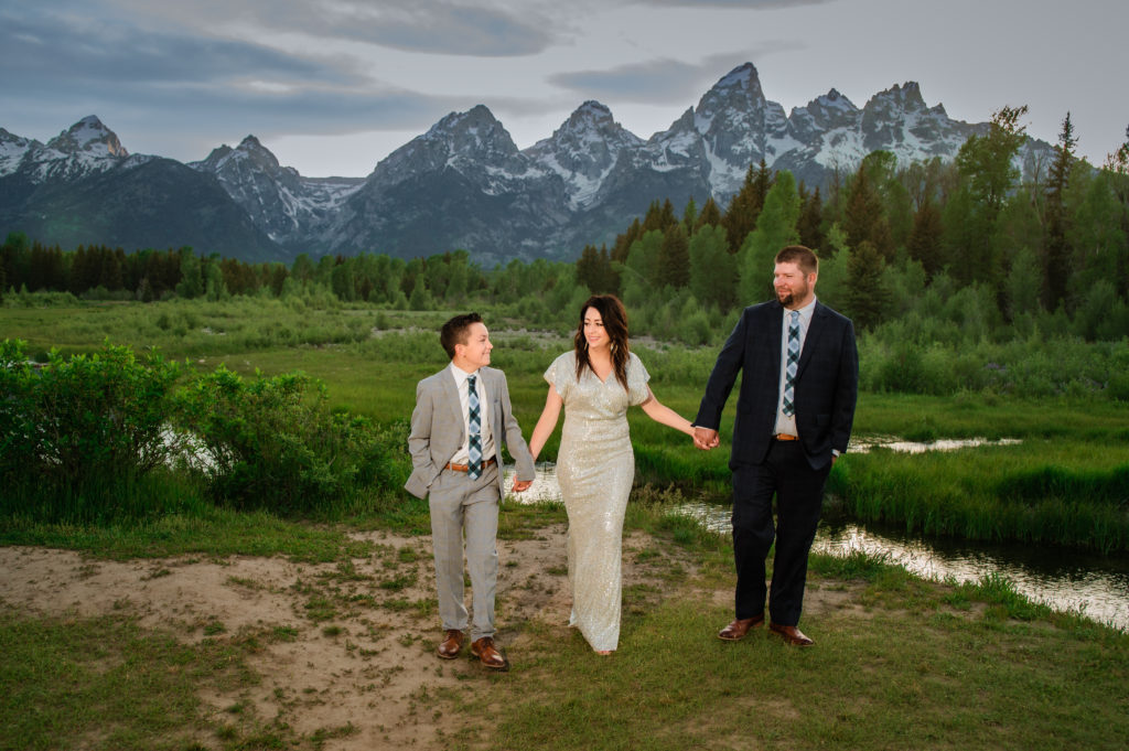 Jackson Hole elopement photographer captures family walking together after jackson hole wedding fun