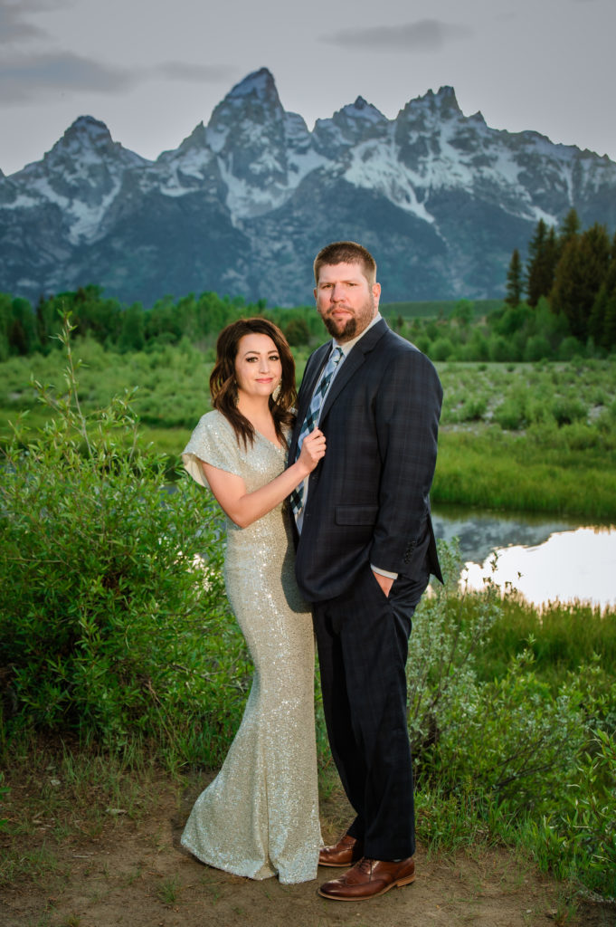 Jackson Hole elopement photographer captures woman wearing sparkly wedding dress and man wearing navy suit in grand teton wedding