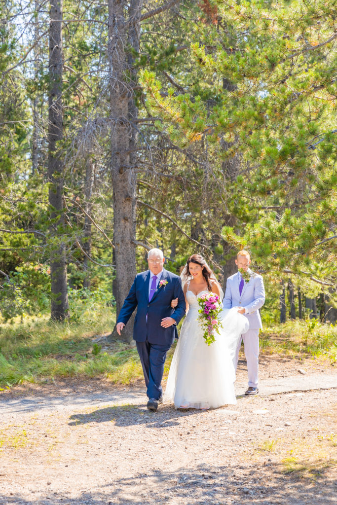 Jackson Hole elopement photographer captures bride being walked into elopement ceremony by father
