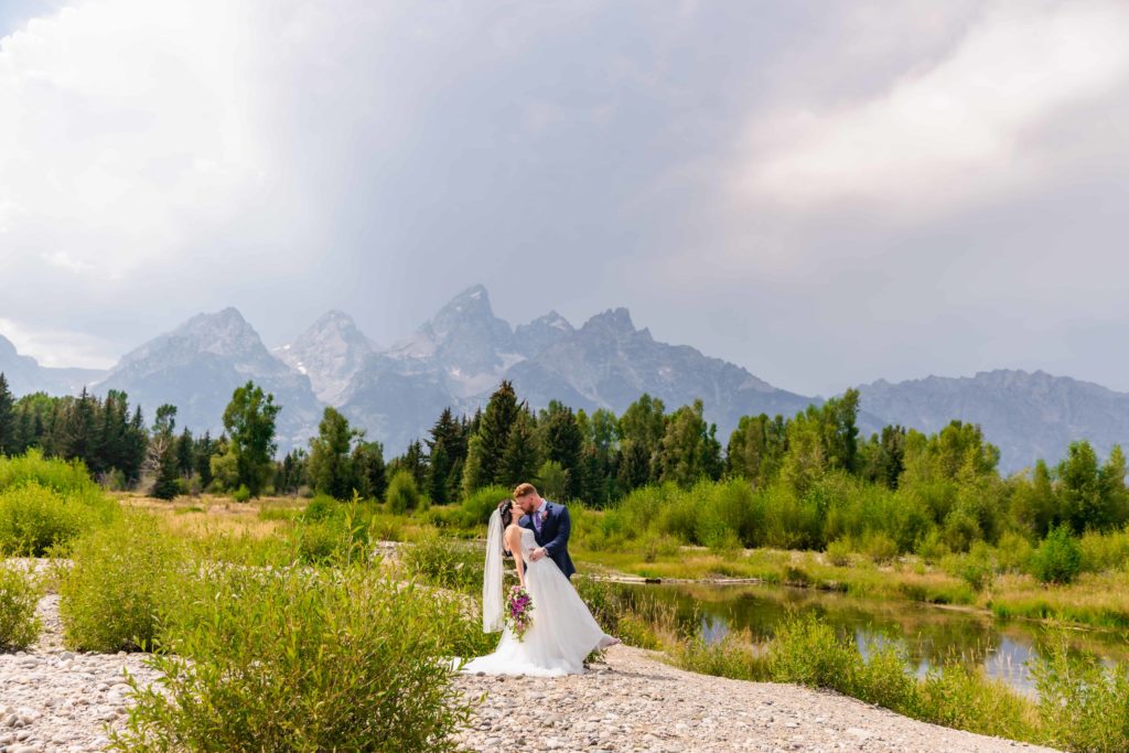 Jackson Hole wedding photographer captures bride and groom kissing after Grand Teton wedding