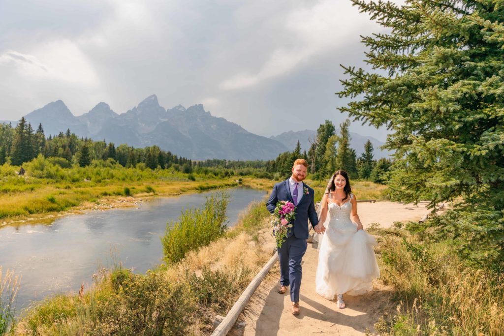 Jackson Hole wedding photographer captures couple walking through Grand Teton park as husband and wife