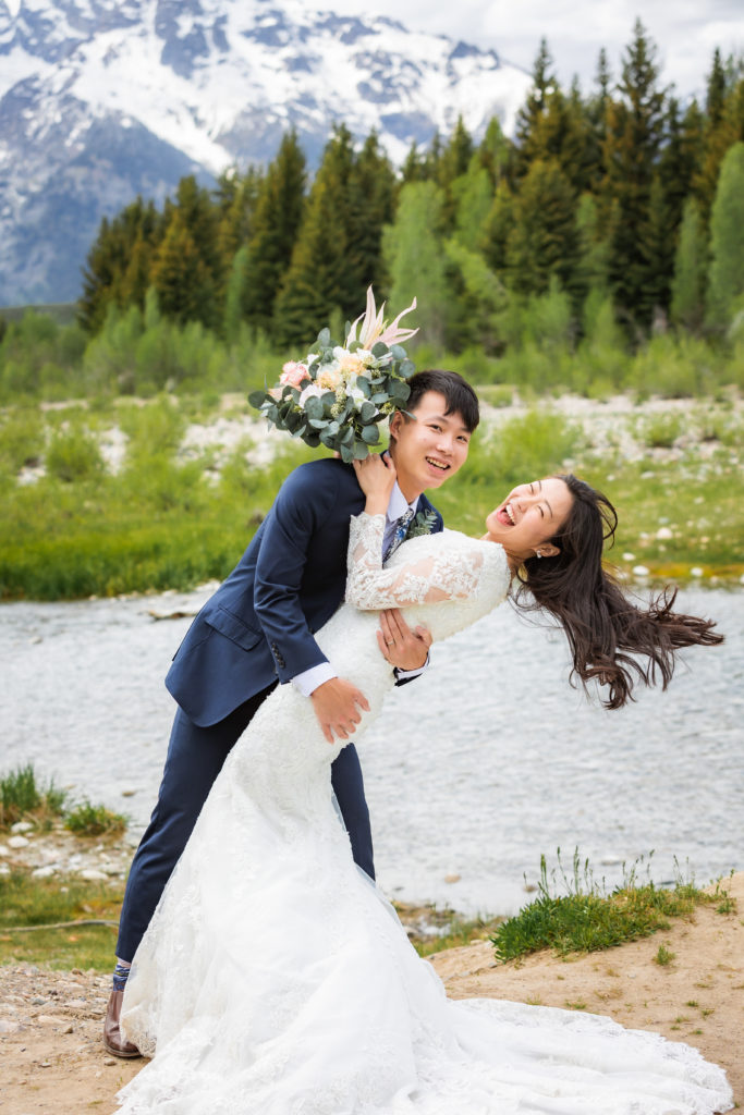 Jackson Hole wedding photographer captures groom dipping bride in portraits 