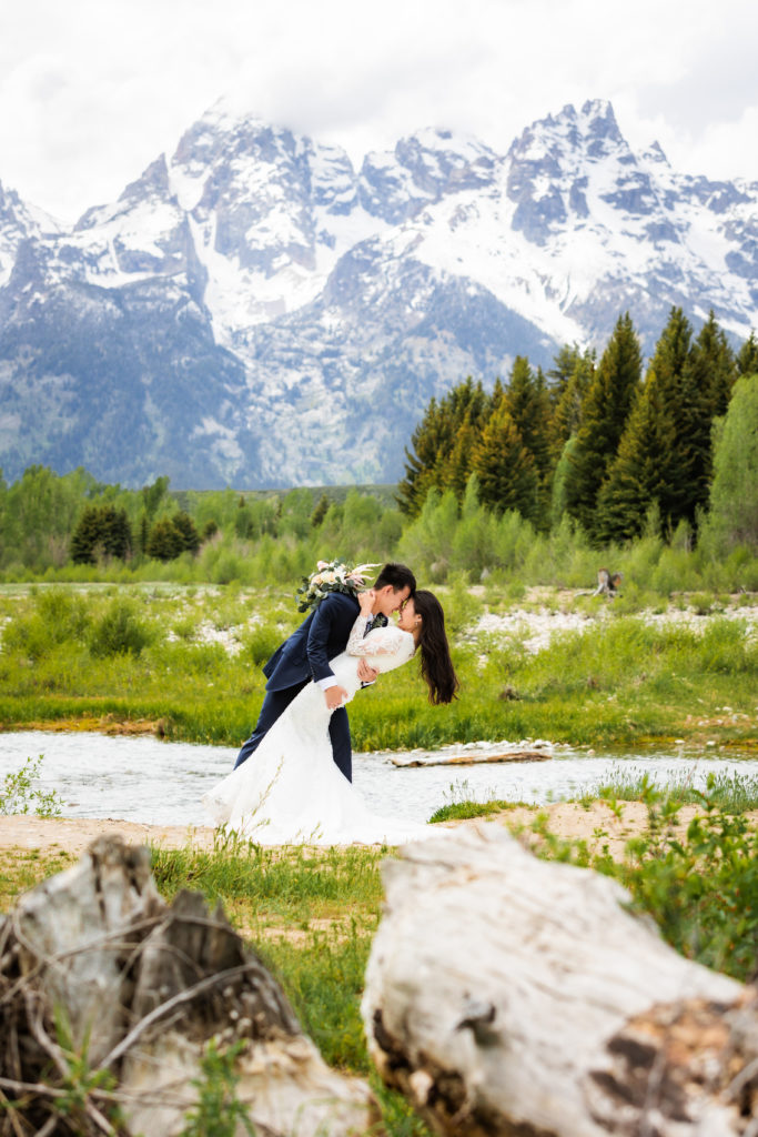 Jackson Hole wedding photographer captures bride and groom kissing after Schwabacher Landing wedding