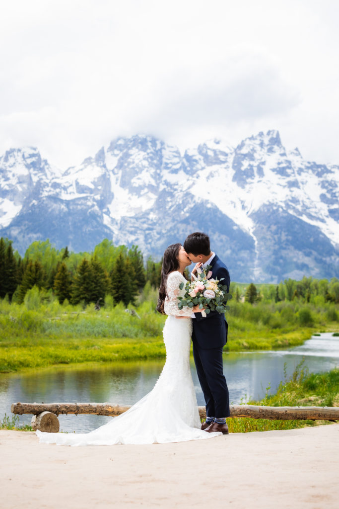 Jackson Hole elopement photographer captures couple kissing during schwabacher landing wedding