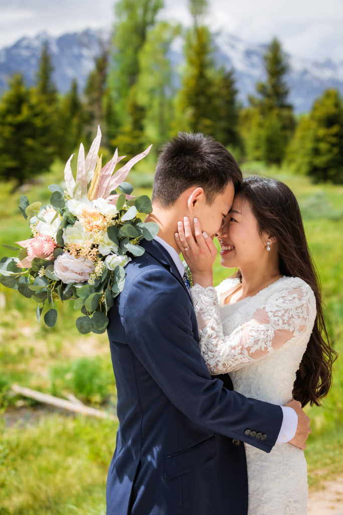 Jackson Hole wedding photographer captures couple kissing during bridal portraits