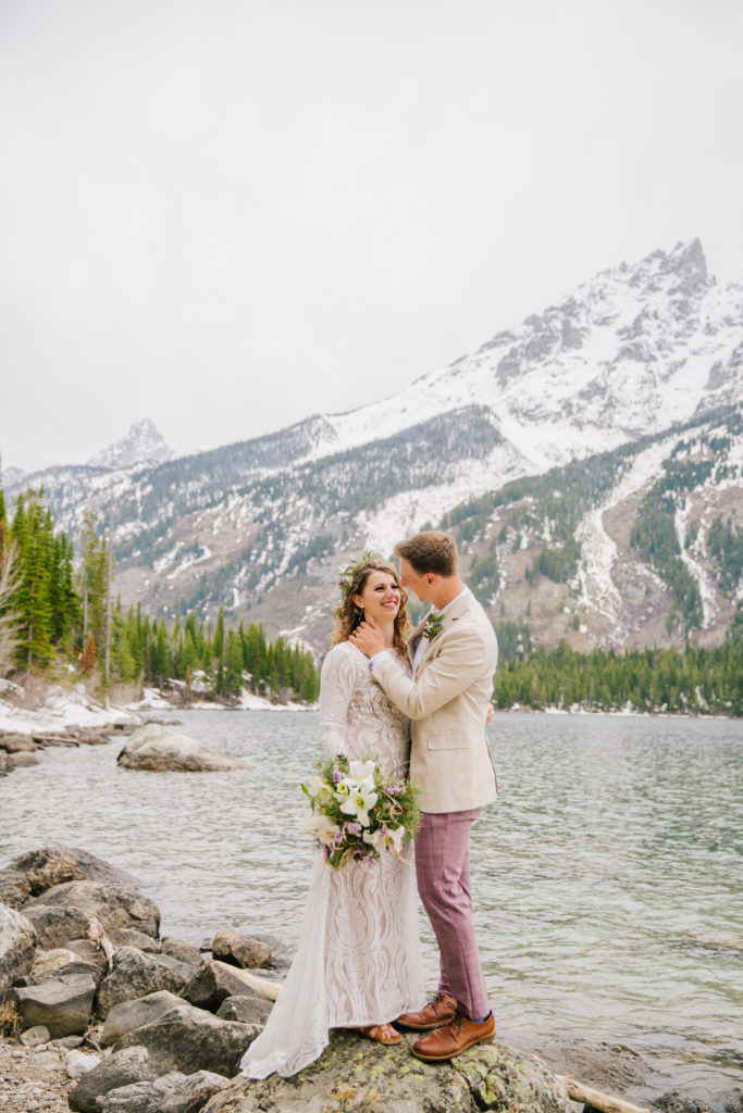 Jackson Hole wedding photographer captures couple kissing at Jenny Lake in Grand Teton National Park elopement