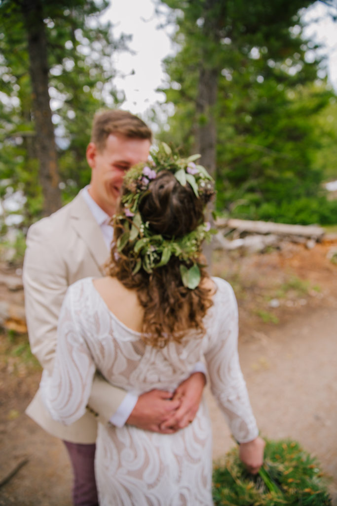 Jackson Hole wedding photographer captures bride from behind embracing her groom