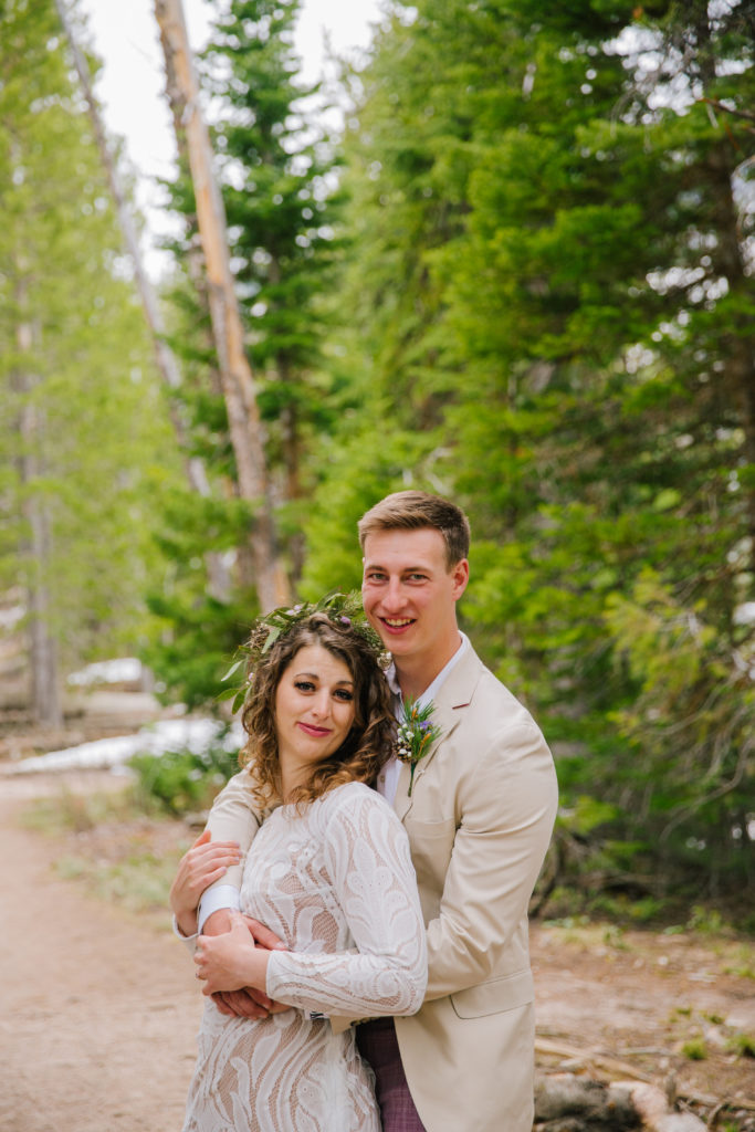 Jackson Hole elopement photographer captures couple hugging in forest after grand teton wedding