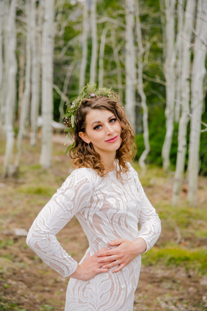Jackson Hole wedding photographer captures bride wearing long sleeve lace gown in grand teton wedding portraits