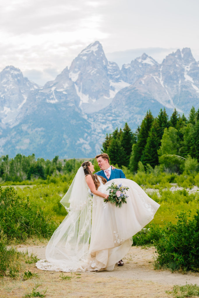 Jackson Hole photographers captures groom dip kissing bride in Jackson Hole wedding