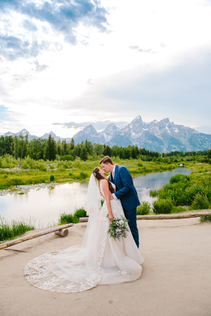 Jackson Hole photographers capture couple kissing and hugging during Grand Teton wedding