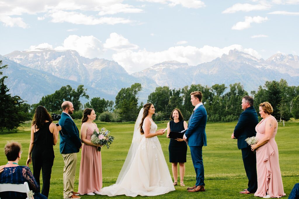 Jackson Hole wedding photographers capture bride and groom getting married in Jackson Hole Golf + Tennis Club